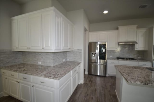 121 Bright Valley Way, Austin, TX 78737 - kitchen with stainless steel refrigerator with ice dispenser, gas stovetop, white cabinets, under cabinet range hood, and dark wood-style flooring