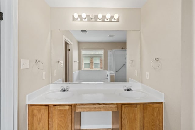 117 Kerley Dr, Hutto, TX 78634 - full bathroom featuring a shower stall, double vanity, and a garden tub