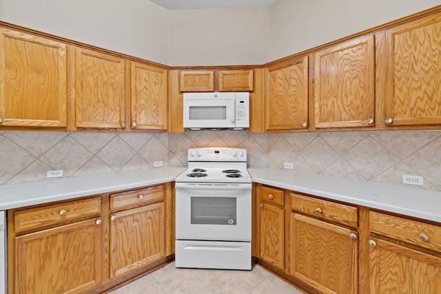 117 Kerley Dr, Hutto, TX 78634 - kitchen featuring white appliances, tasteful backsplash, light countertops, and light tile patterned floors