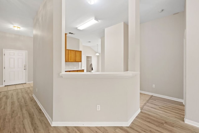 117 Kerley Dr, Hutto, TX 78634 - hall with light wood-style flooring, baseboards, and lofted ceiling