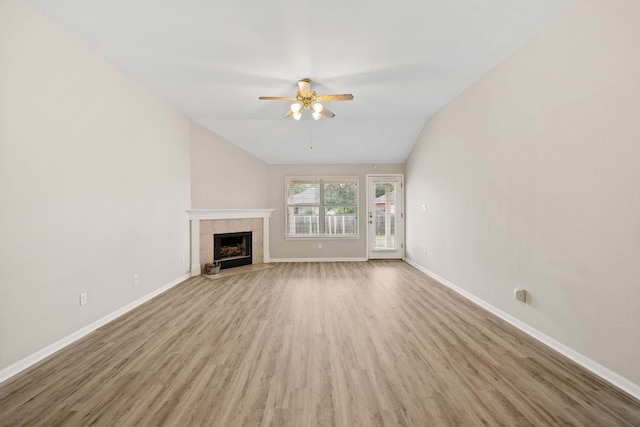 117 Kerley Dr, Hutto, TX 78634 - unfurnished living room with ceiling fan, wood finished floors, baseboards, a tile fireplace, and lofted ceiling