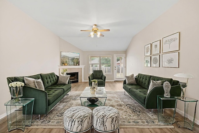 117 Kerley Dr, Hutto, TX 78634 - living area with a ceiling fan, vaulted ceiling, wood finished floors, a fireplace, and baseboards