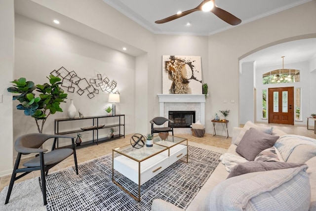 15901 Double Eagle Dr, Austin, TX 78717 - tiled living area with arched walkways, a ceiling fan, ornamental molding, recessed lighting, and a glass covered fireplace