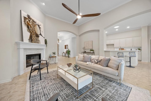 15901 Double Eagle Dr, Austin, TX 78717 - living room featuring arched walkways, a ceiling fan, crown molding, light tile patterned floors, and recessed lighting