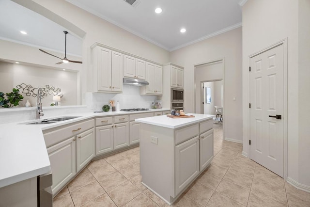 15901 Double Eagle Dr, Austin, TX 78717 - kitchen featuring a sink, stainless steel microwave, crown molding, a center island, and light countertops