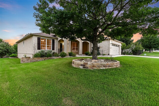 107 Apache Mountain Ln, Georgetown, TX 78633 - view of front of house with a front yard, driveway, a garage, and stucco siding