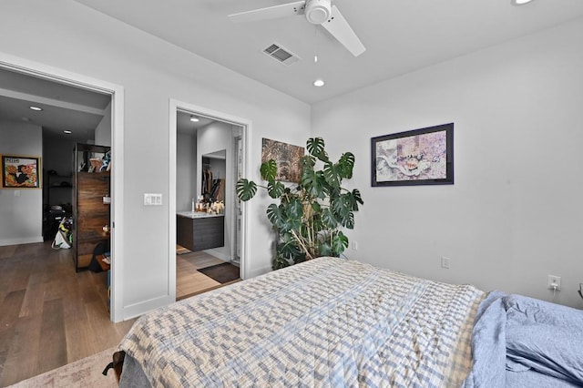 1800 E 4th St Unit 335, Austin, TX 78702 - bedroom featuring wood finished floors, baseboards, ceiling fan, recessed lighting, and connected bathroom