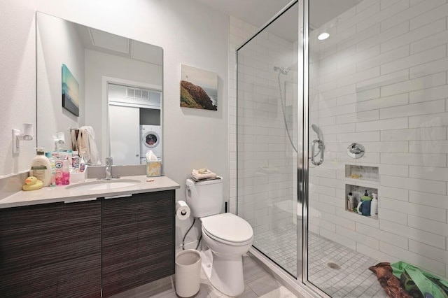 1800 E 4th St Unit 335, Austin, TX 78702 - bathroom with vanity, a shower stall, toilet, and washer / dryer