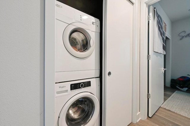 1800 E 4th St Unit 335, Austin, TX 78702 - washroom with stacked washer / drying machine and light wood-style flooring