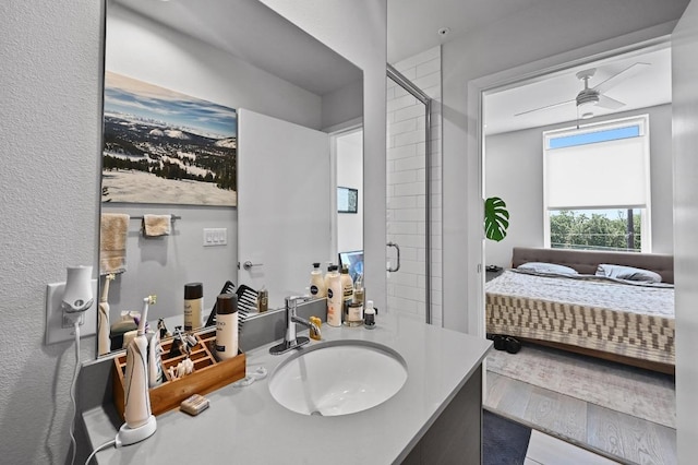 1800 E 4th St Unit 335, Austin, TX 78702 - full bathroom featuring connected bathroom, a shower stall, vanity, and wood finished floors
