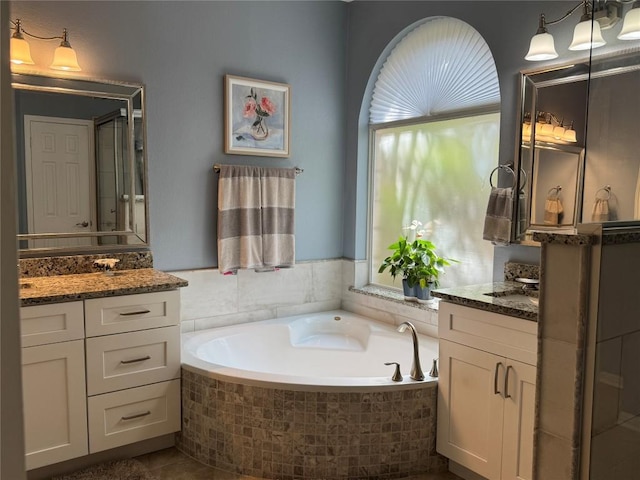 2619 Henley Dr, Round Rock, TX 78681 - full bathroom with two vanities and a garden tub