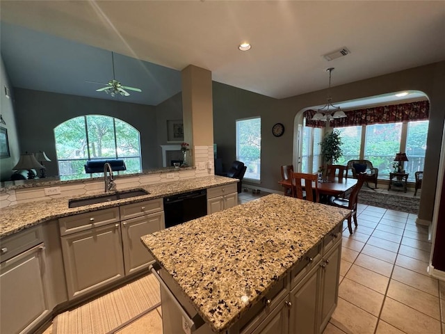 2619 Henley Dr, Round Rock, TX 78681 - kitchen featuring a sink, dishwasher, a ceiling fan, light stone countertops, and arched walkways