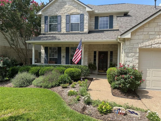 2619 Henley Dr, Round Rock, TX 78681 - traditional home with stone siding, a shingled roof, covered porch, and a garage