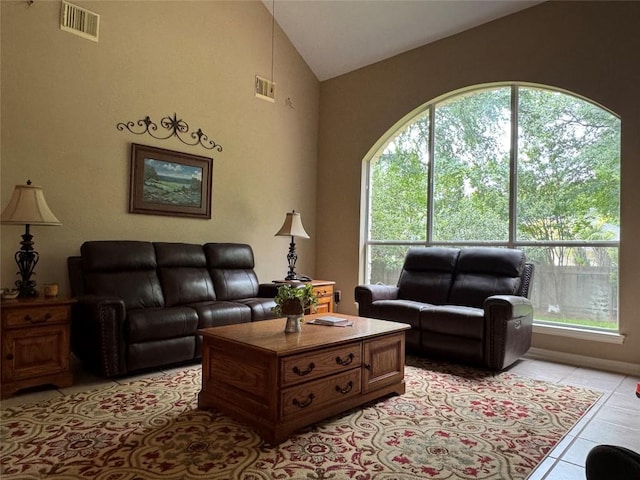 2619 Henley Dr, Round Rock, TX 78681 - living room featuring lofted ceiling, healthy amount of natural light, and light tile patterned floors