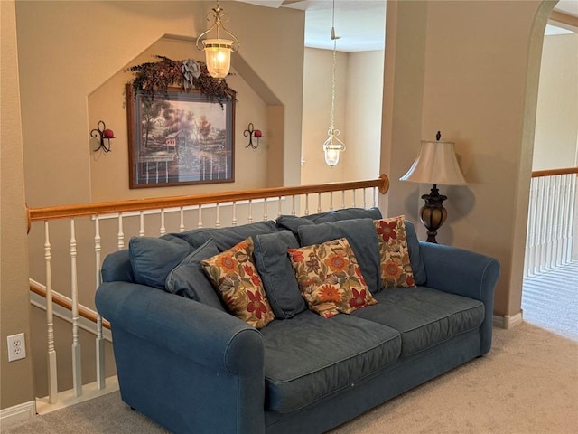 2619 Henley Dr, Round Rock, TX 78681 - living area featuring carpet floors, baseboards, and arched walkways