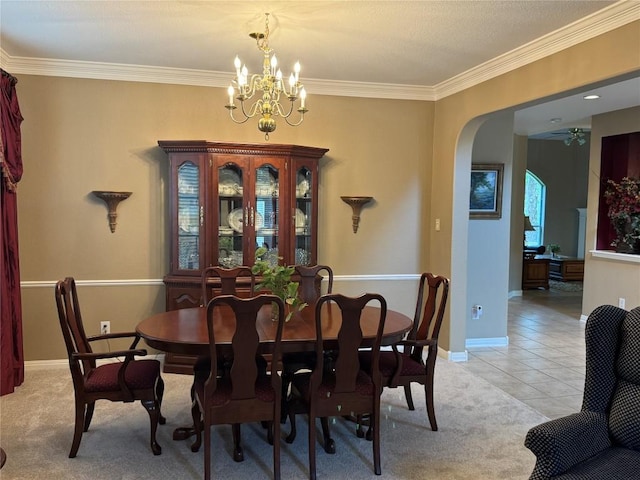 2619 Henley Dr, Round Rock, TX 78681 - dining space with ornamental molding, arched walkways, a chandelier, light tile patterned floors, and light carpet