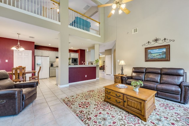 2619 Henley Dr, Round Rock, TX 78681 - living area with ceiling fan, light tile patterned floors, and a towering ceiling