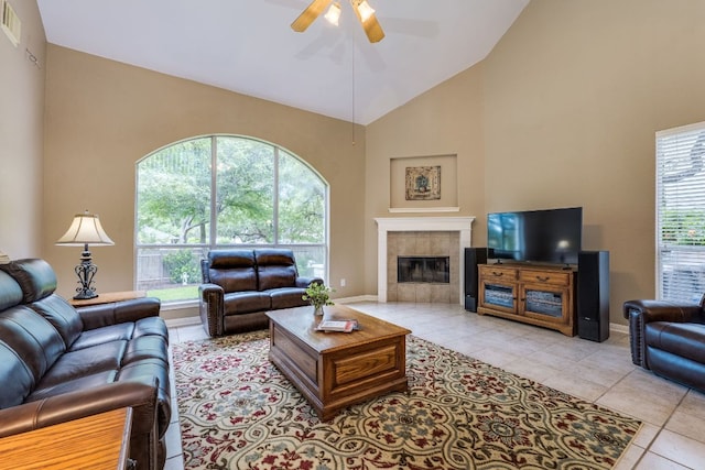 2619 Henley Dr, Round Rock, TX 78681 - living room featuring a ceiling fan, high vaulted ceiling, light tile patterned floors, plenty of natural light, and a tile fireplace
