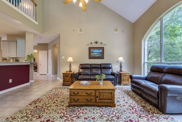 2619 Henley Dr, Round Rock, TX 78681 - living room with high vaulted ceiling, ceiling fan, plenty of natural light, light tile patterned flooring, and arched walkways