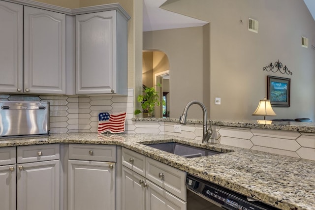 2619 Henley Dr, Round Rock, TX 78681 - kitchen featuring dishwasher, decorative backsplash, light stone countertops, and white cabinets
