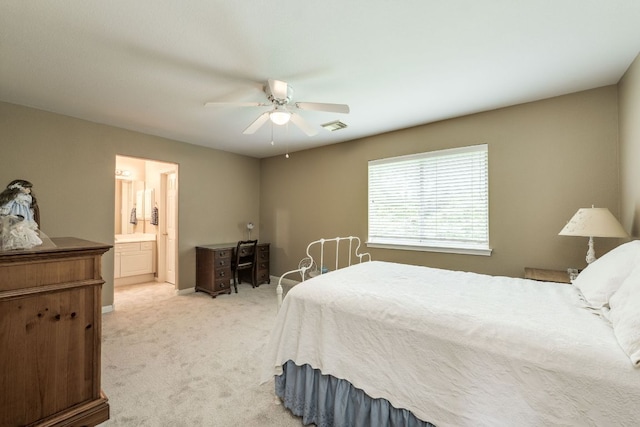 2619 Henley Dr, Round Rock, TX 78681 - bedroom with light colored carpet, ensuite bath, and a ceiling fan