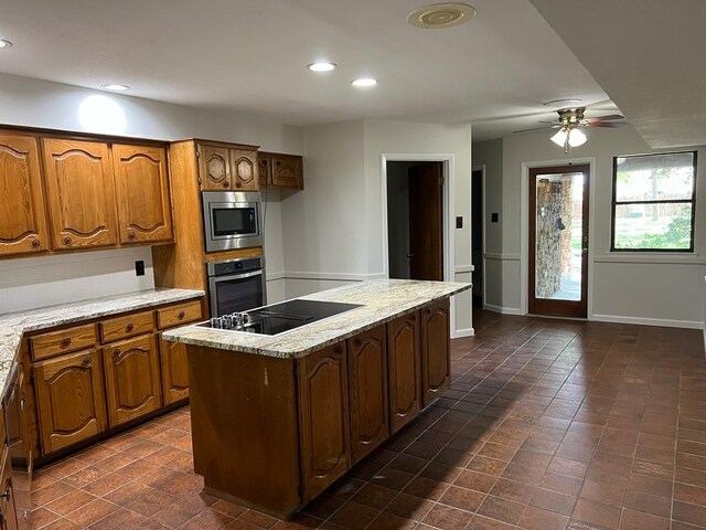 TBD County Road 246, Florence, TX 76527 - kitchen featuring stainless steel appliances, brown cabinetry, ceiling fan, a center island, and recessed lighting