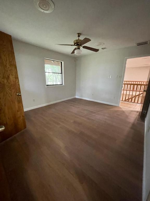 TBD County Road 246, Florence, TX 76527 - spare room with wood finished floors, ceiling fan, and baseboards