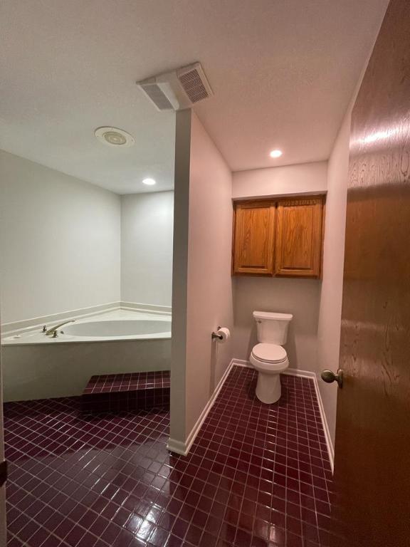 TBD County Road 246, Florence, TX 76527 - full bath with a garden tub, toilet, tile patterned floors, baseboards, and recessed lighting