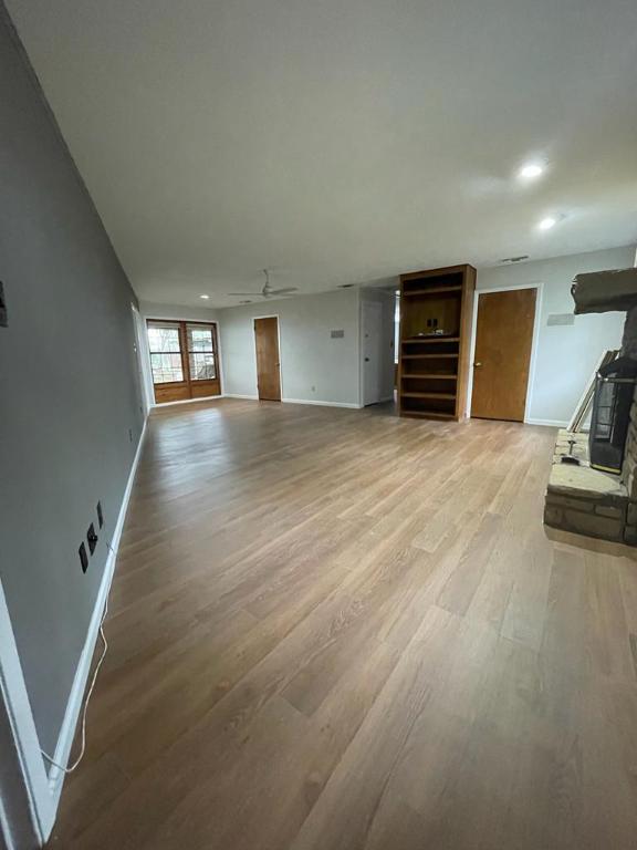 TBD County Road 246, Florence, TX 76527 - unfurnished living room featuring light wood-style flooring, baseboards, and recessed lighting