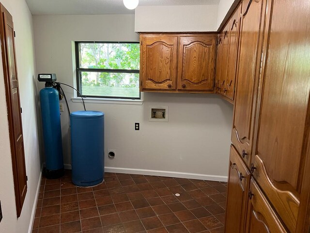 TBD County Road 246, Florence, TX 76527 - laundry area featuring dark tile patterned flooring, washer hookup, and baseboards