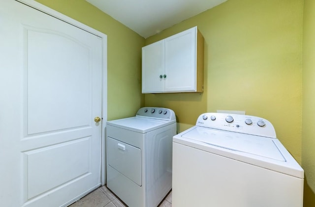 5013 Cleves St, Round Rock, TX 78681 - laundry area featuring cabinet space, separate washer and dryer, and light tile patterned floors