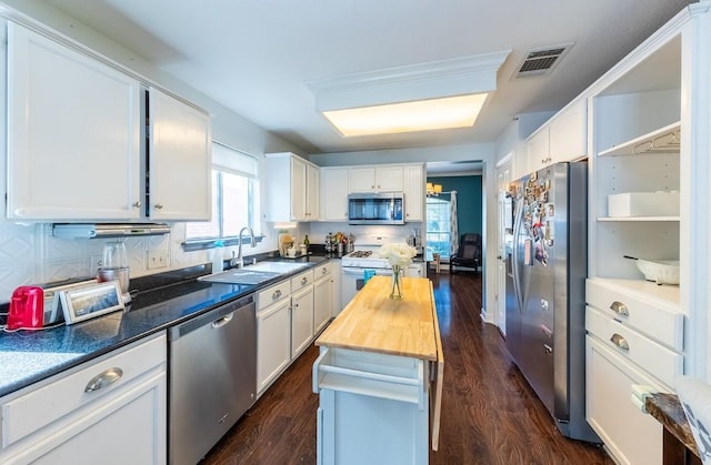 5013 Cleves St, Round Rock, TX 78681 - kitchen featuring stainless steel appliances, open shelves, white cabinets, butcher block counters, and dark wood-type flooring