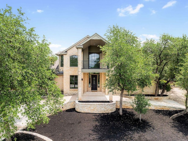 307 Malabar St, Lakeway, TX 78734 - view of exterior entry featuring a balcony and brick siding