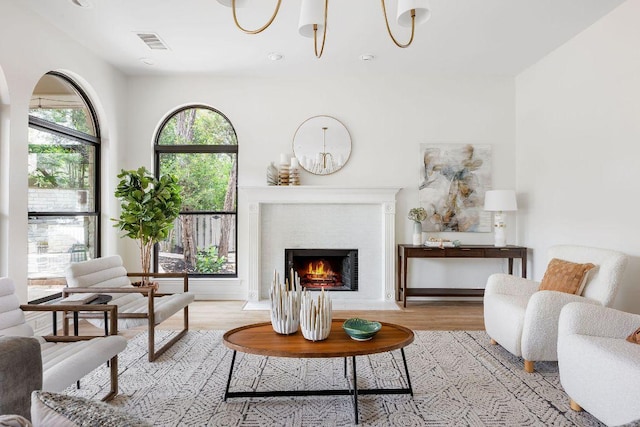 307 Malabar St, Lakeway, TX 78734 - living area featuring a chandelier, light wood finished floors, and a fireplace with flush hearth