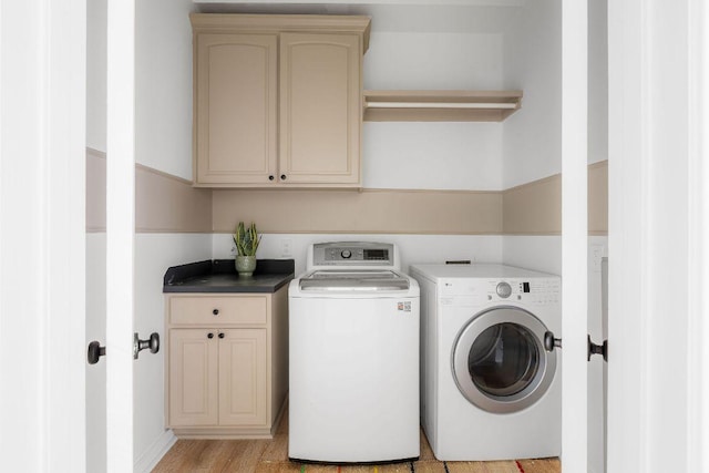 307 Malabar St, Lakeway, TX 78734 - laundry room featuring separate washer and dryer, cabinet space, and light wood finished floors