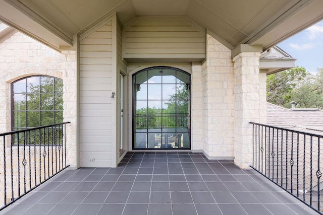 307 Malabar St, Lakeway, TX 78734 - view of exterior entry featuring a balcony and stone siding
