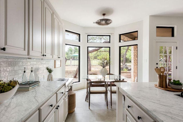307 Malabar St, Lakeway, TX 78734 - kitchen with plenty of natural light, backsplash, light stone countertops, and light tile patterned floors
