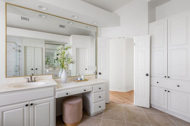 307 Malabar St, Lakeway, TX 78734 - bathroom featuring a stall shower, vanity, and tile patterned flooring
