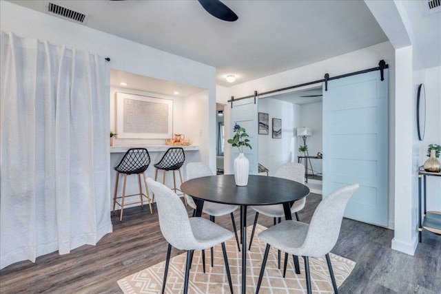 3210 Kay St, Austin, TX 78702 - dining space with a barn door and wood finished floors