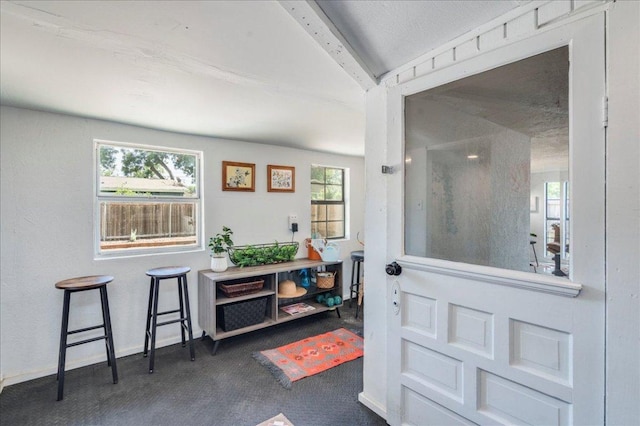 3210 Kay St, Austin, TX 78702 - foyer featuring beam ceiling and carpet flooring