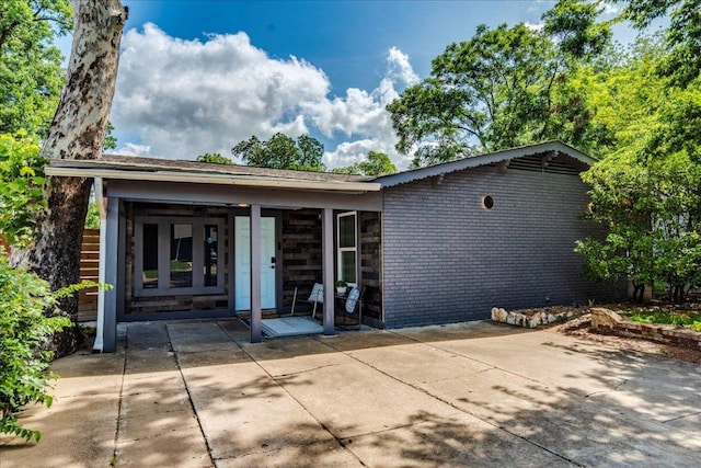 3210 Kay St, Austin, TX 78702 - view of front facade featuring a patio area and brick siding