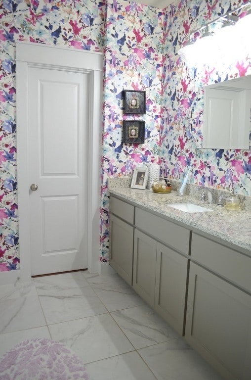 13501 Metric Blvd Unit 42, Austin, TX 78727 - bathroom featuring wallpapered walls, vanity, and marble finish flooring