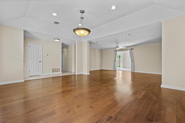 3601 Arrowhead Dr, Austin, TX 78731 - unfurnished living room with wood finished floors, a tray ceiling, a ceiling fan, baseboards, and recessed lighting