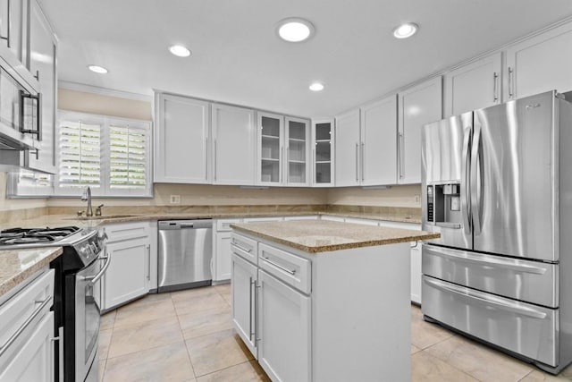 3601 Arrowhead Dr, Austin, TX 78731 - kitchen with appliances with stainless steel finishes, a sink, light tile patterned floors, white cabinetry, and recessed lighting