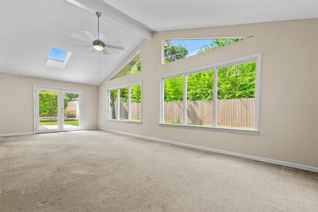 3601 Arrowhead Dr, Austin, TX 78731 - carpeted empty room featuring baseboards, a skylight, a ceiling fan, beam ceiling, and high vaulted ceiling