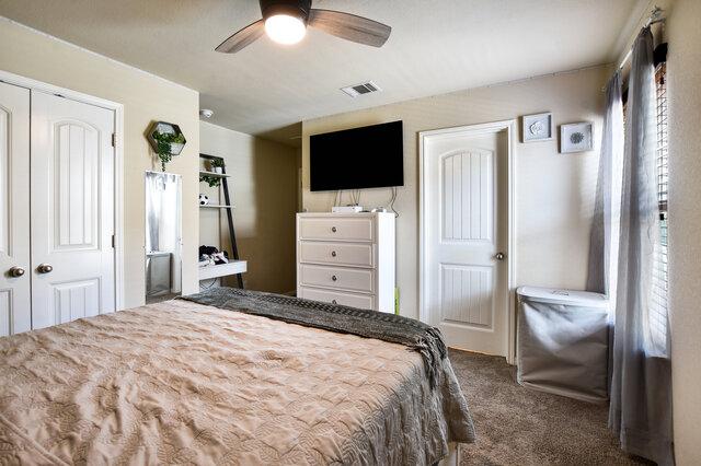 624 Purtis Creek Ln, Georgetown, TX 78628 - bedroom with carpet, a closet, and a ceiling fan