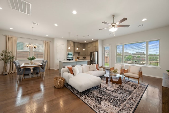 1416 Reprise Bnd, Round Rock, TX 78681 - living room featuring baseboards, recessed lighting, hardwood / wood-style flooring, ceiling fan, and a chandelier