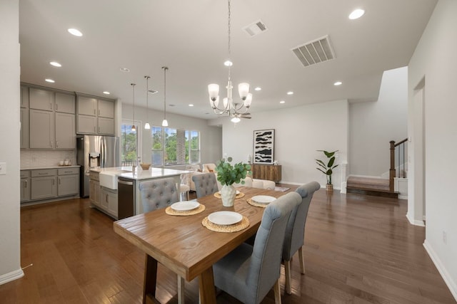 1416 Reprise Bnd, Round Rock, TX 78681 - dining room with stairs, a chandelier, recessed lighting, baseboards, and dark wood-style floors
