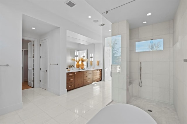 1047 Overlook Pkwy, Horseshoe Bay, TX 78657 - full bathroom featuring vanity, a walk in shower, a soaking tub, recessed lighting, and tile patterned floors