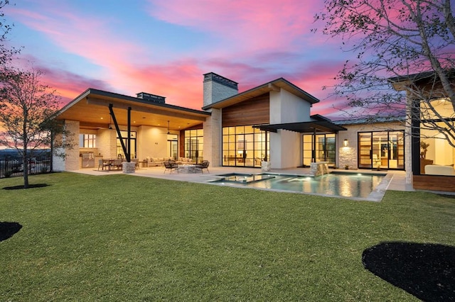 1047 Overlook Pkwy, Horseshoe Bay, TX 78657 - back of house at dusk with a chimney, a patio, ceiling fan, and a pool with connected hot tub